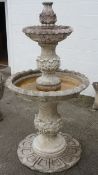 A cast stone two tier fountain, possibly reconstituted marble,