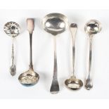 A collection of assorted silver ladles,