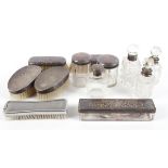 A collection of silver and silver plated bottles and dressing table items,