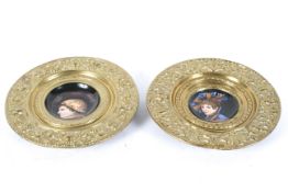 A pair of Continental brass chargers,