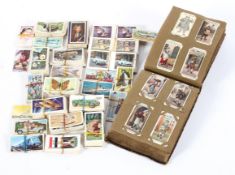 A collection of vintage Player's Cigarette cards, some mounted in an antique leather effect album,