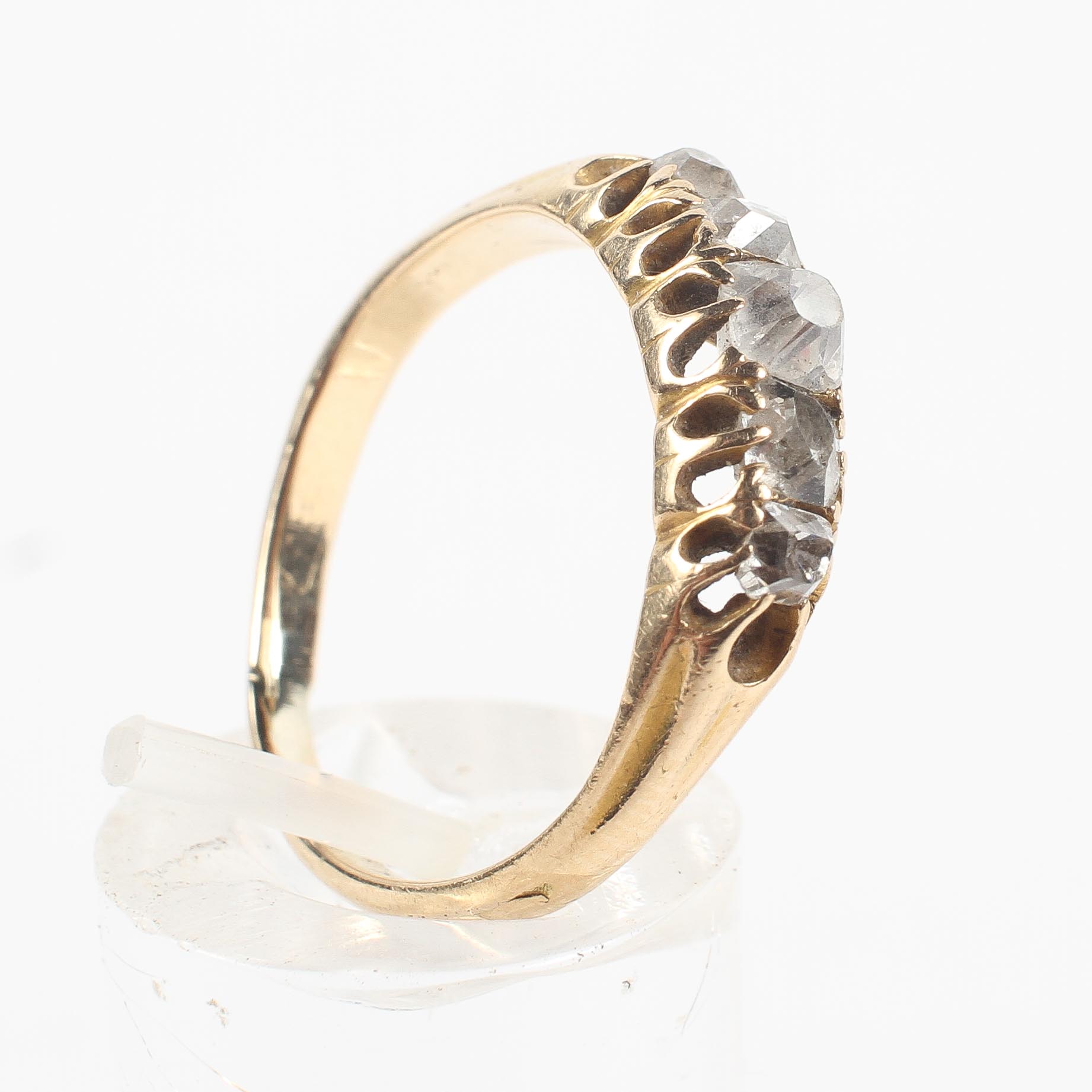 A yellow metal half hoop ring.