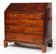A George III mahogany bureau, the fall front enclosing a fitted interior, above four cockbeaded,