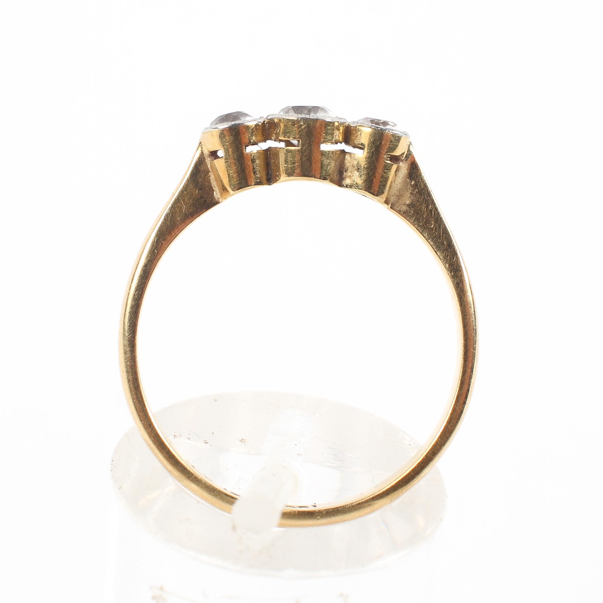 A yellow metal three stone ring set with three graduated round cut white stones; - Image 3 of 4