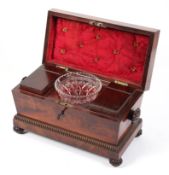 A William IV mahogany sarcophagus shaped tea caddy, with gadrooned borders and bun feet,