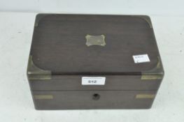 A late 19th/early 20th century mahogany brass bound vanity box, opening to reveal fitted interior,