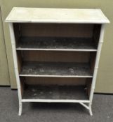 A white painted bamboo set of shelves,