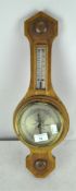 A pale oak wall barometer and thermometer, made in England,