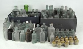A large collection of vintage glass bottles, in assorted colours,