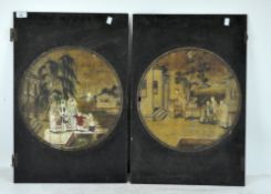A pair of Chinese painted cupboard doors, adorned with traditional scenes of people by buildings,