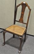 A 19th century chair with bergere seat, cabriole supports,