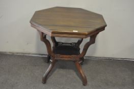 A mahogany hexagonal tiered occasional coffee table on casters,