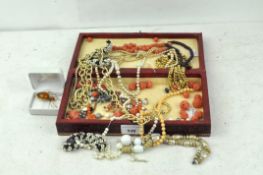A selection of assorted costume jewellery, in Russian box, including beads,