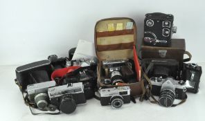 A collection of vintage cameras, to include a Canon T70 with neck strap, an Asahi Pentax SP 1000,