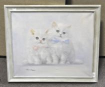 An oil on canvas depicting two white kittens, indistinctly signed to bottom left, framed,