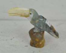 A stone figure of a toucan,