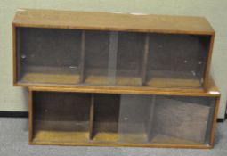 A pair of oak mid-century Unix horizontal wall display cases with sliding glass doors,