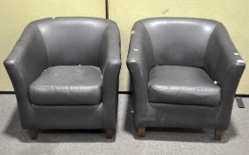 A pair of tub chairs, raised on wooden feet,