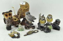 A selection of owl figurines, including ceramic, wooden,
