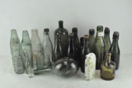 A selection of vintage glass bottles, to include lemonade bottles from Bristol, green ovoid bottle,