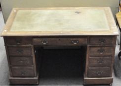 A mahogany twin pedestal desk with one central drawer flanked by four drawers each side,