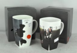 Two Mackenzie Thorpe limited edition 'Game of Life' mugs, comprising; We'll beat them next time,