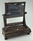 A Victorian mahogany dressing table swing mirror, raised above two drawers,