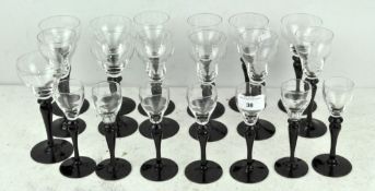 A selection of wine glasses, in three sizes, each with black stems, largest 16.5cm high