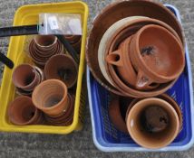 A collection of assorted terracotta plant pots in small to medium sizes (two baskets)