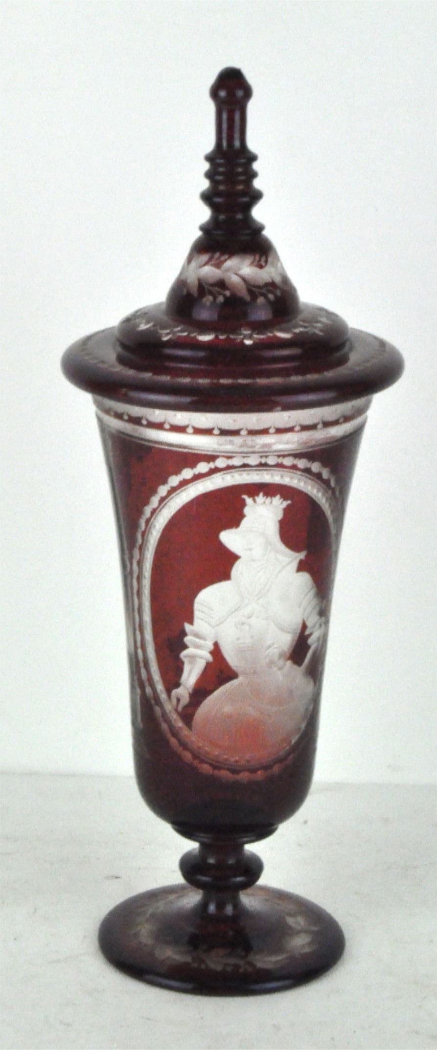 A late 19th century Bohemian ruby glass lidded vase,