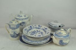 A collection of various blue and white ceramics including dishes, tea and coffee pots,
