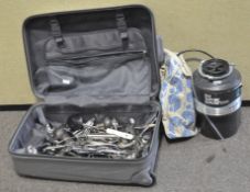 A suitcase containing silver plate,