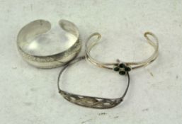 Three continental white metal torque bangles,