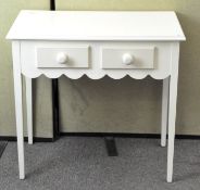 A painted two drawer hall table by Laura Ashley, raised upon tapering squared supports,