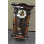 A Vienna stye wall clock within a mahogany case with floral decoration,