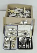 A collection of assorted silver plated flatware, including butter knives,