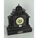 An Edwardian black slate mantel clock with marble inlaid decoration,