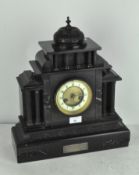 An Edwardian black slate mantel clock with marble inlaid decoration,