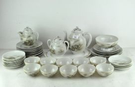 A Japanese porcelain tea set, decorated with landscape scenes, comprising cups and saucers,