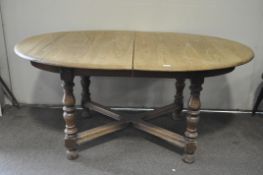 A vintage Ercol style extendable oval dining table,