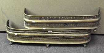 Two brass fenders, the largest with ornate pierced and moulded decoration,