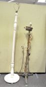 Two 20th century standard lamps, one being white painted wood, the other brass,