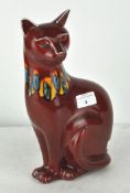 A Poole pottery 'Delphis' red Volcano figure of a seated cat,