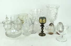 A collection of assorted glassware, including wine glasses, two paperweights,