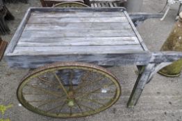 A wooden cart with Victorian wheels,