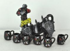 A novelty tea pot, in the form of a Poodle dog, with matching cups,