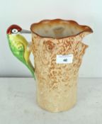 A mid century Royal Falcon ware water jug in the form of a woodpecker on a tree trunk,