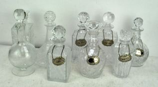 Nine 20th Century glass decanters, of various shapes and sizes,