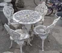A set of aluminium white painted table and four chairs cast with scrolls, height of chairs 85 cm,