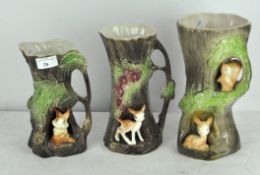 A group of three similar Eastgate Withernsea poruing jugs in the form of trees with animals to side,